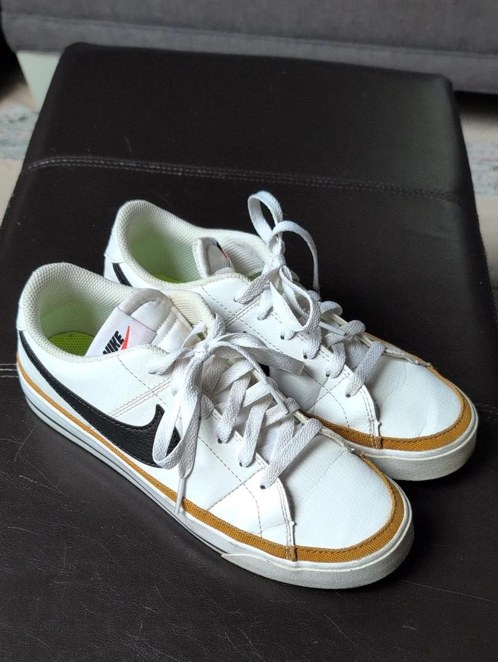 Nike Women’s White Sneakers with Black Swoosh and Gold Trim